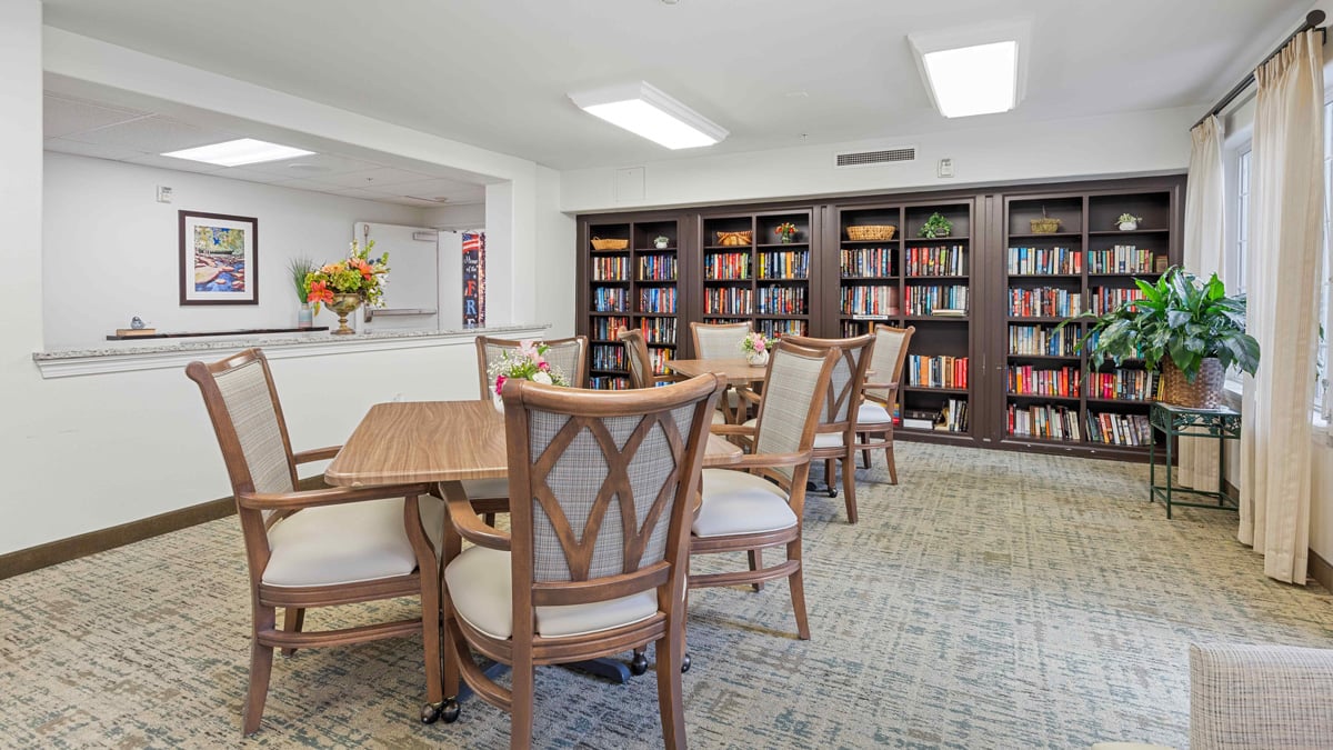 The library at Bella Vista with shelves of books and comfortable seating
